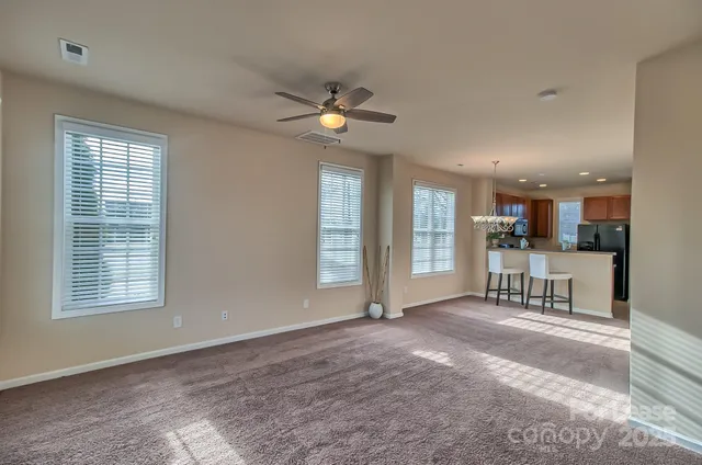 a view of an empty room with a kitchen