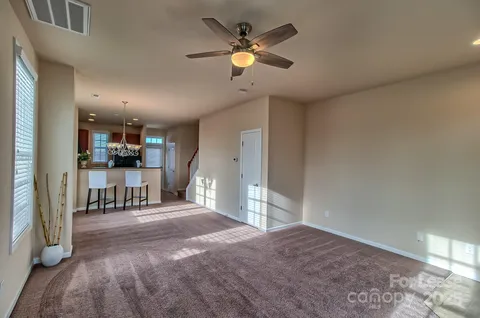 a view of kitchen with furniture and a ceiling fan