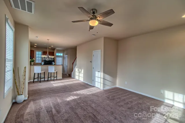 a view of kitchen with furniture and a ceiling fan