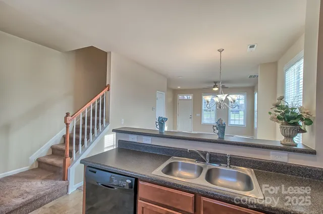 a kitchen with a sink and chandelier