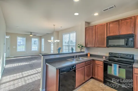 a kitchen with a sink stove and microwave