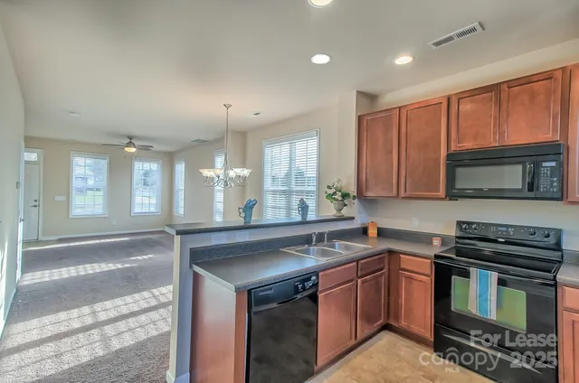 a kitchen with a sink stove and microwave