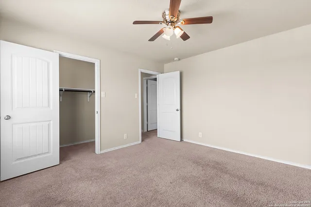 a view of an empty room with a fan