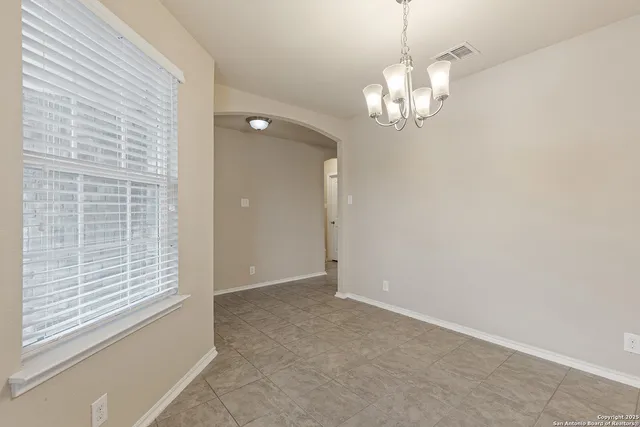 a view of a chandelier in big room and chandelier