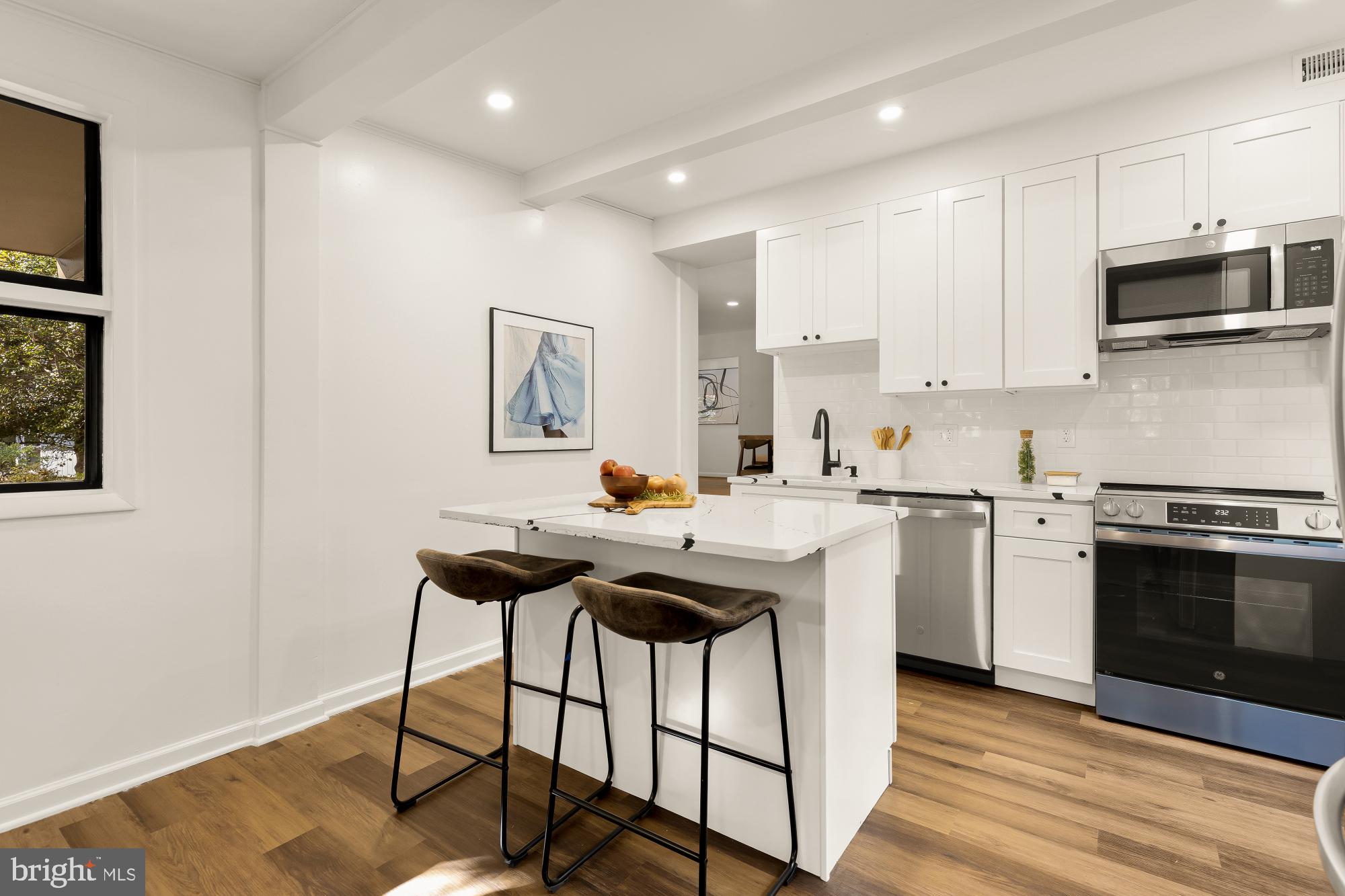 4911 Falstone Avenue Chevy Chase, MD 20815 - Photo 19 of 58 a kitchen with a stove a sink and a microwave