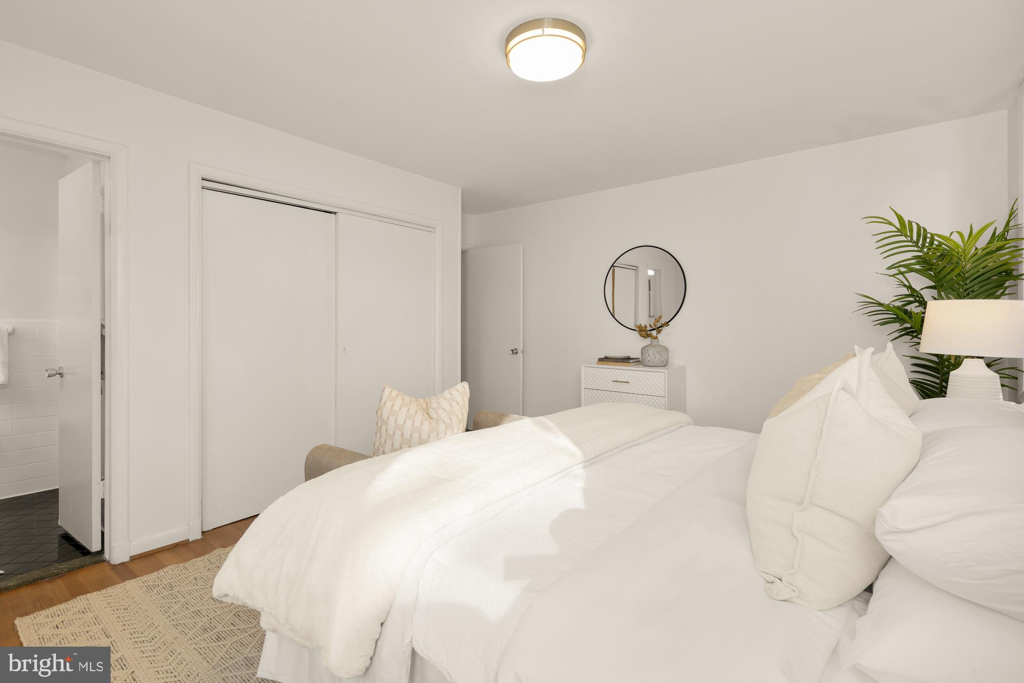 4911 Falstone Avenue Chevy Chase, MD 20815 - Photo 26 of 58 a bedroom with a bed and a potted plant