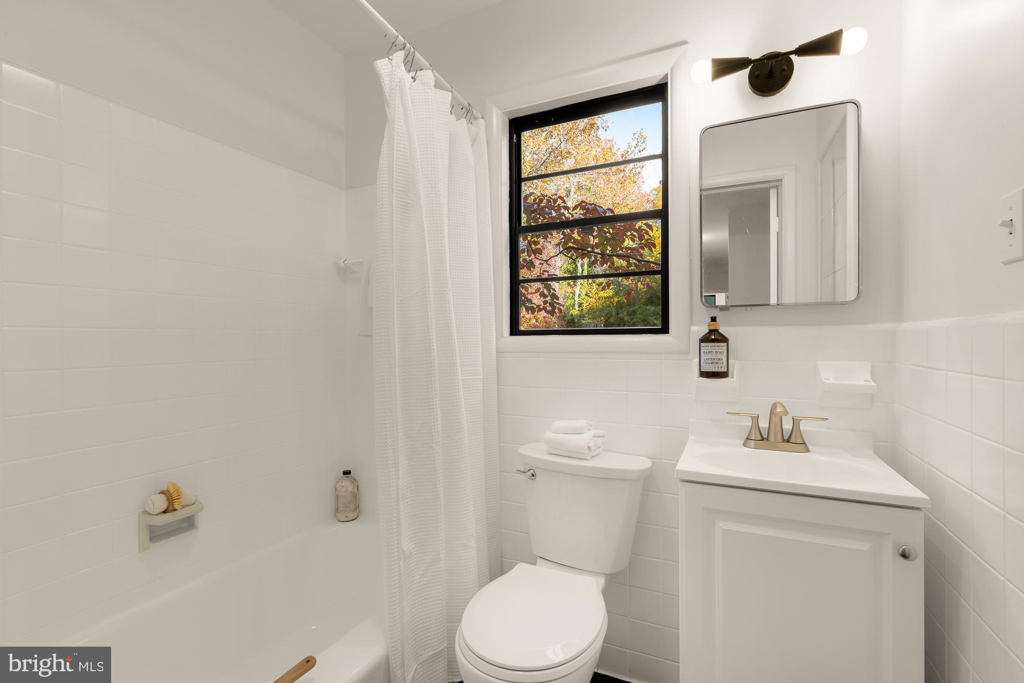 4911 Falstone Avenue Chevy Chase, MD 20815 - Photo 31 of 58 a white toilet sitting next to a bathroom sink