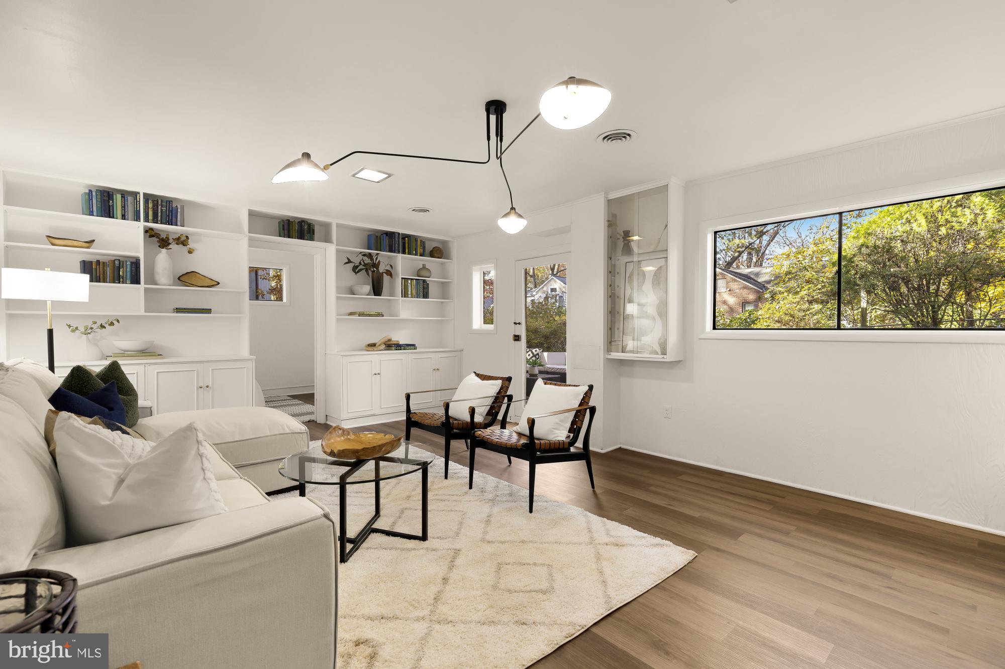 4911 Falstone Avenue Chevy Chase, MD 20815 - Photo 35 of 58 a living room with furniture a flat screen tv and a large window