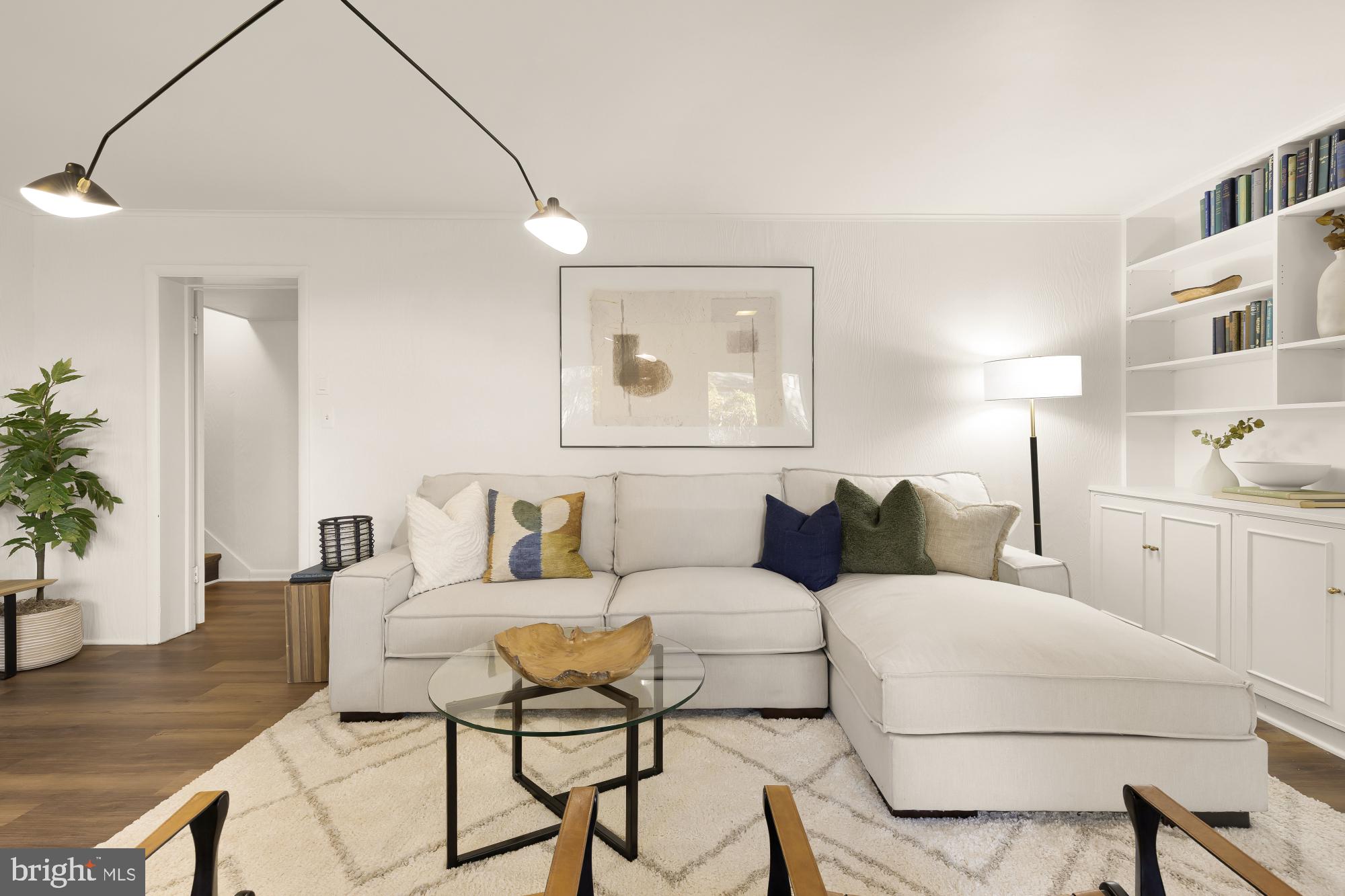 4911 Falstone Avenue Chevy Chase, MD 20815 - Photo 36 of 58 a living room with furniture and a painting on the wall