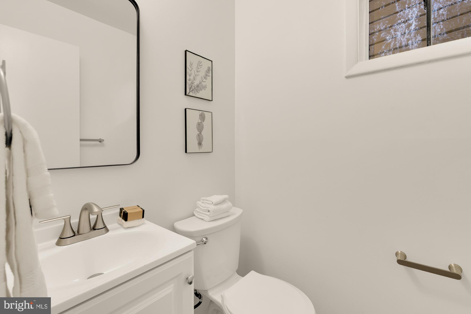 4911 Falstone Avenue Chevy Chase, MD 20815 - Photo 41 of 58 a bathroom with a sink mirror and toilet