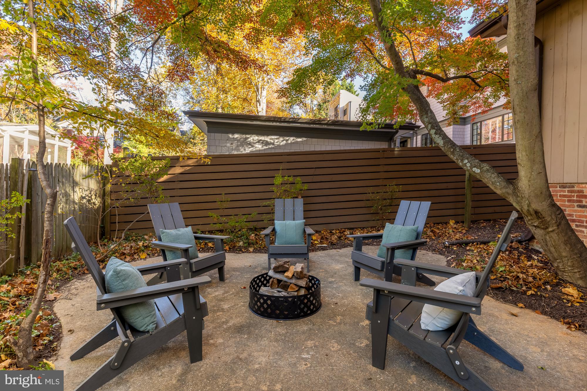 4911 Falstone Avenue Chevy Chase, MD 20815 - Photo 45 of 58 a backyard of a house with barbeque oven table and chairs