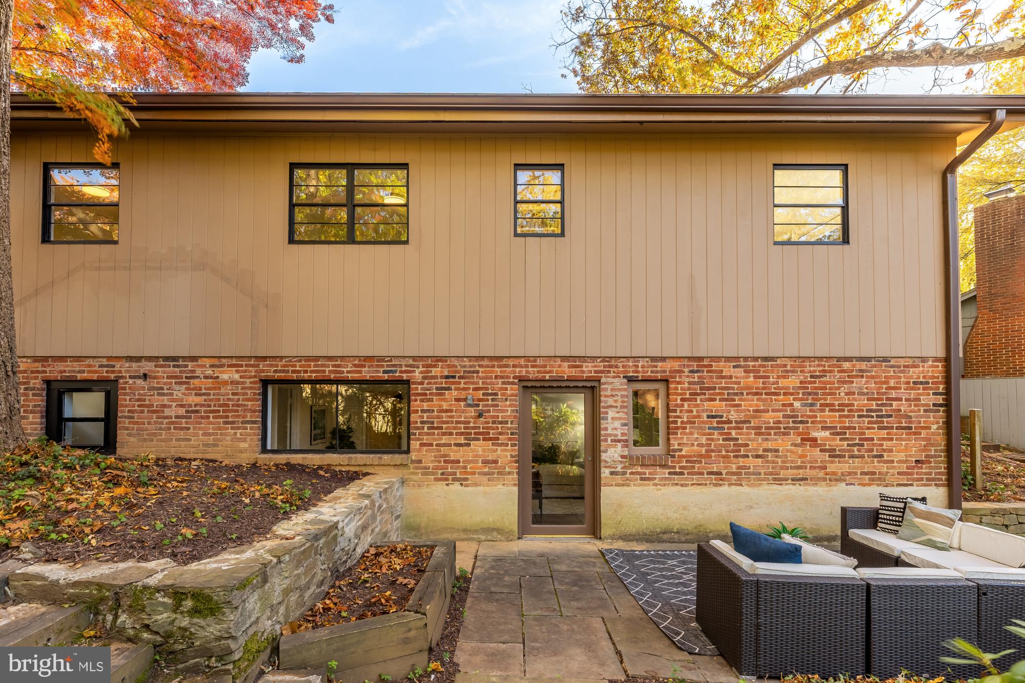 4911 Falstone Avenue Chevy Chase, MD 20815 - Photo 46 of 58 a front view of a house with glass top table and chairs