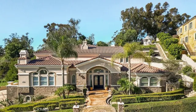 a front view of a house with a garden