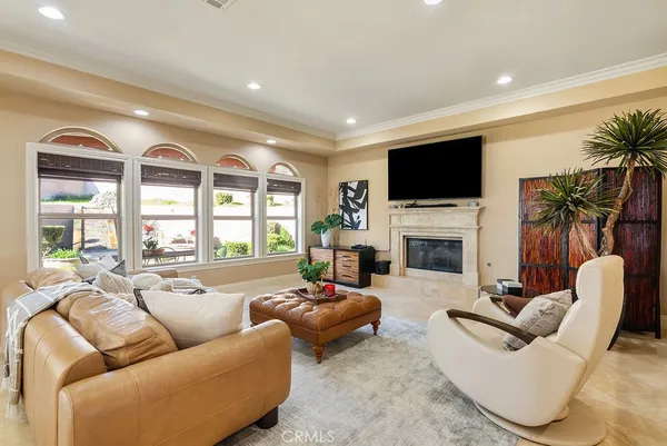 a living room with furniture a large window and a flat screen tv