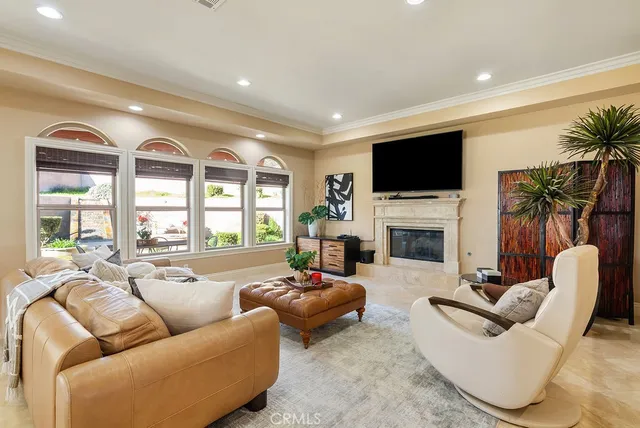a living room with furniture a large window and a flat screen tv