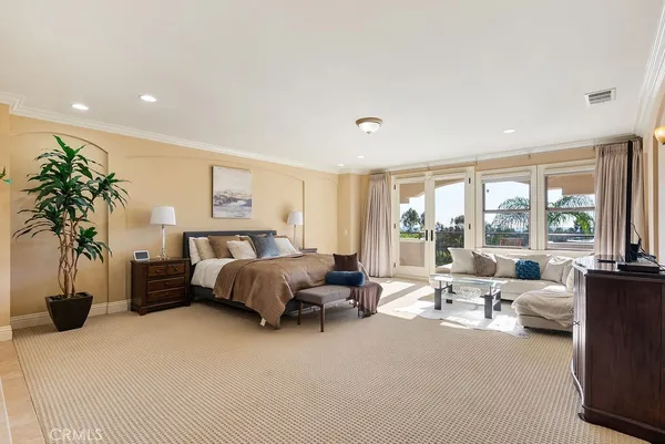 a bedroom with furniture and a large window