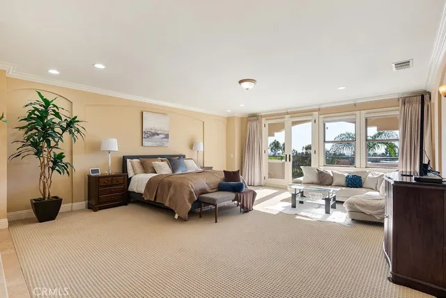 a bedroom with furniture and a large window