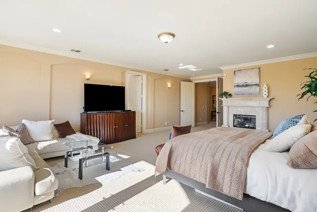 a spacious bedroom with a bed and a flat screen tv