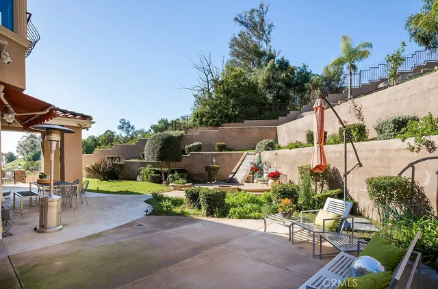 an outdoor space with seating area and garden