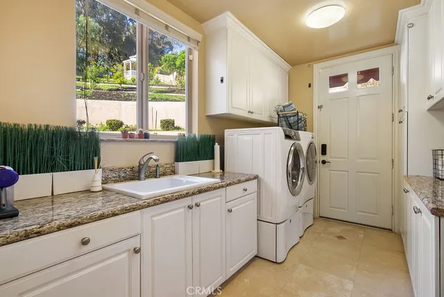 a kitchen with a sink cabinets and window