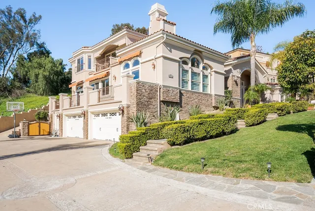 a front view of a house with a garden and plants