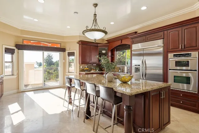 a large kitchen with a table and chairs