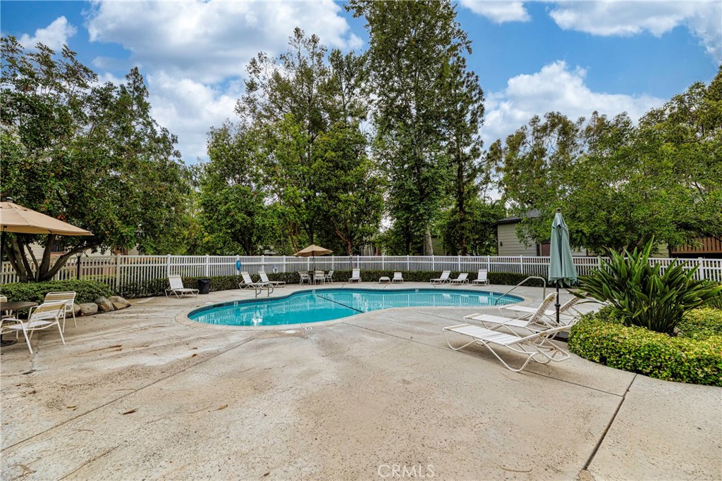 20702 El Toro Road, Unit 178 Lake Forest, CA 92630 - Photo 22 of 30 a view of a backyard with lawn chairs and a fire pit