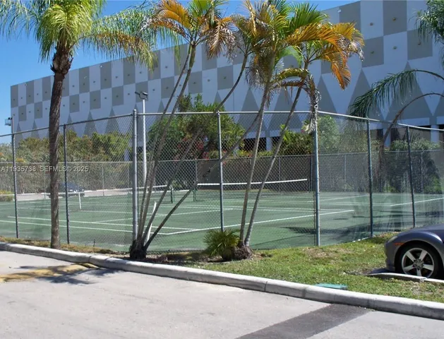 a view of a yard with a house and a car park in front of it