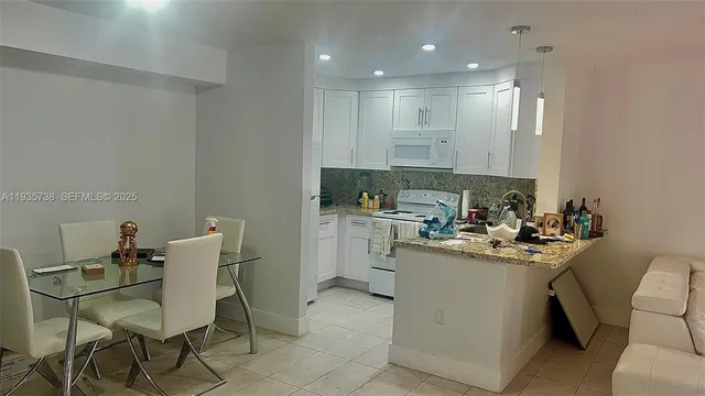 a kitchen with a sink cabinets and wooden floor