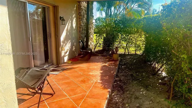a backyard of a house with table and chairs
