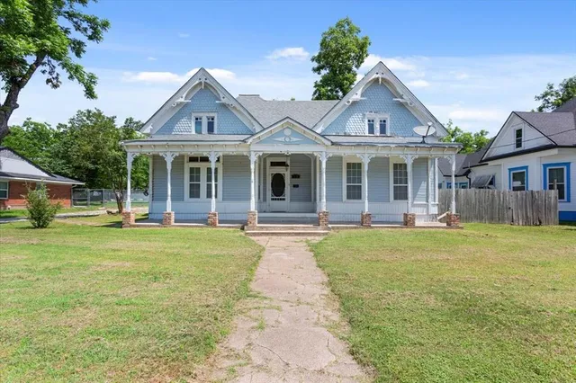 a front view of a house with a garden