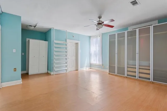 a view of an empty room with a ceiling fan