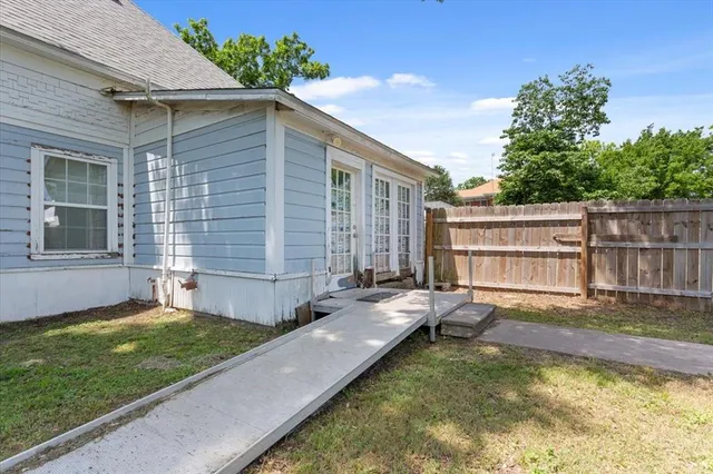 a view of a house with a yard and a patio