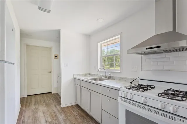 a kitchen that has a sink and a stove