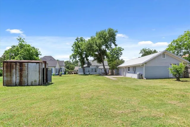 a view of a house with a yard and garage