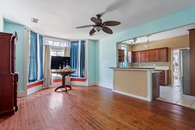 a view of a kitchen with a sink and a refrigerator