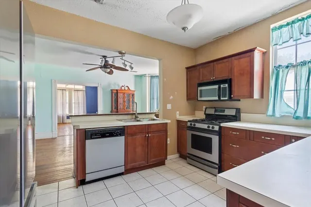 a kitchen with a stove sink and microwave
