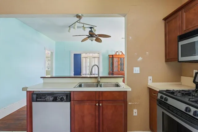a kitchen with a sink a stove and a microwave
