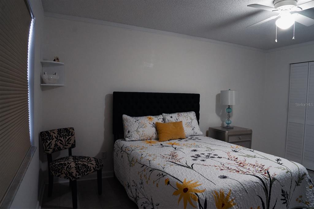 519 Albee Farm Road, Unit 110 Venice, FL 34285 - Photo 11 of 33 a bedroom with a bed and a chandelier