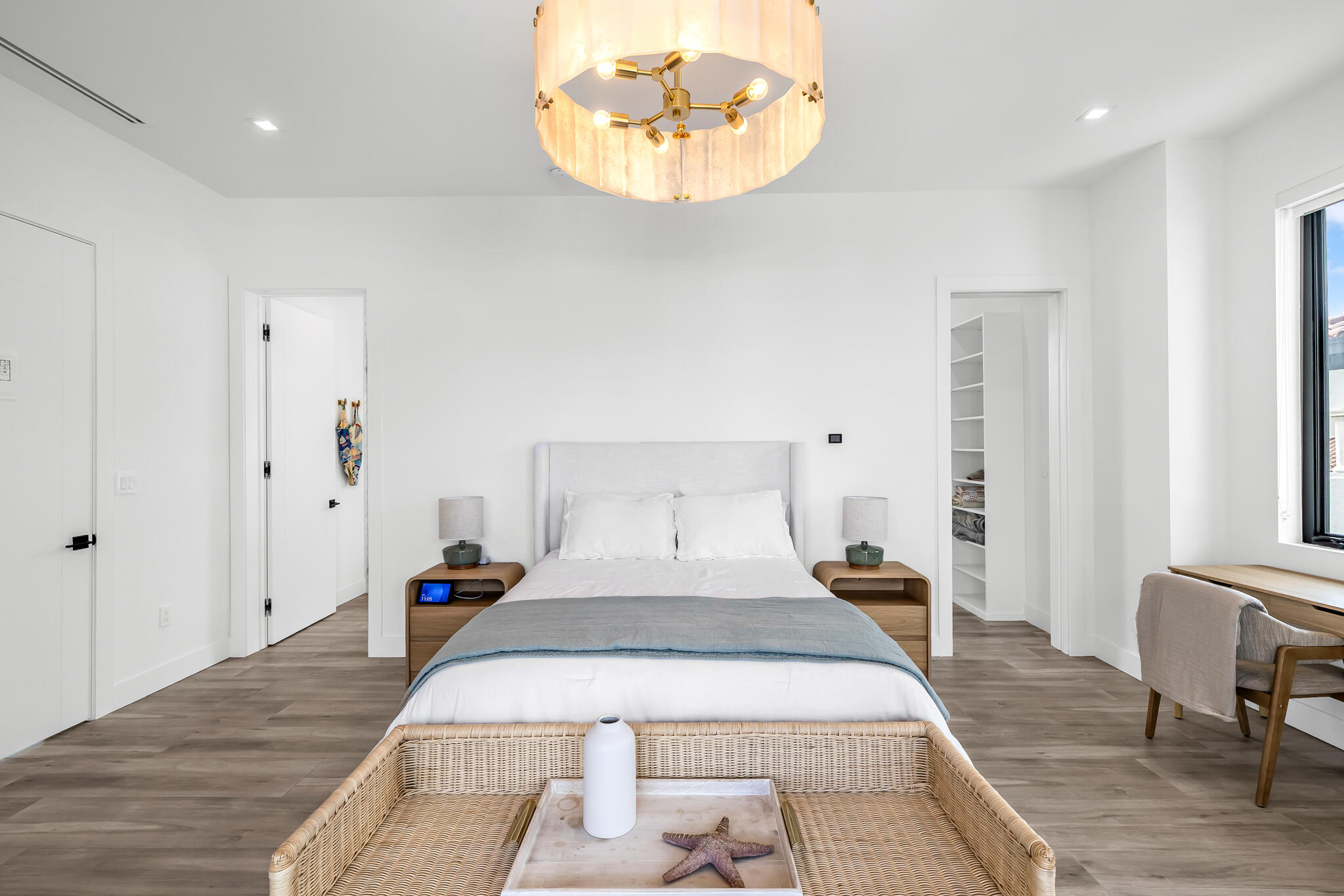 3711 Northeast 30th Avenue Lighthouse Point, FL 33064 - Photo 47 of 57 a bedroom with a large bed and a chandelier
