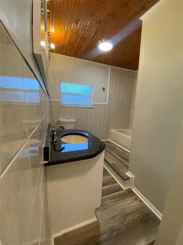 a bathroom with a sink and mirror