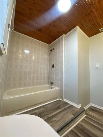 a bathroom with a bathtub and a shower