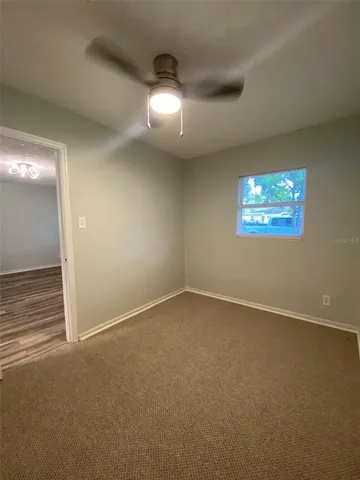 an empty room with windows and entrance