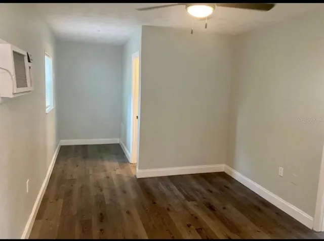a view of a room with wooden floor