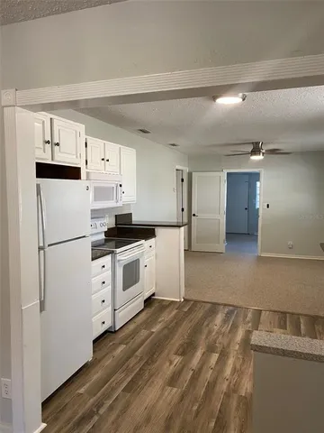 a kitchen with stainless steel appliances a refrigerator sink and cabinets
