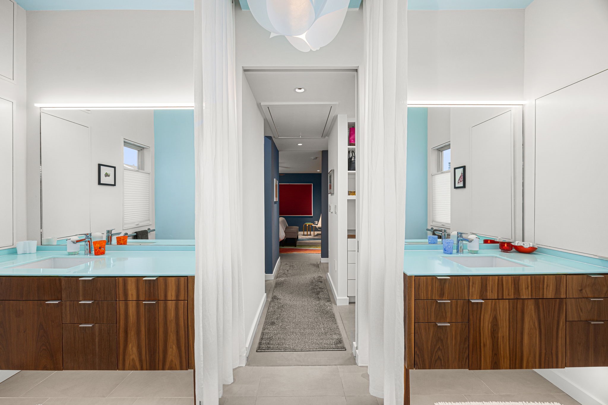 5811 Rose Street Houston, TX 77007 - Photo 20 of 38 What a view! Simplicity and peacefulness from the primary bathroom dual vanities. The curtains create a sense of privacy and warmth, yet allows the space to feel connected. Discover the multiple built-in storage and custom cabinet designs while touring the home.
