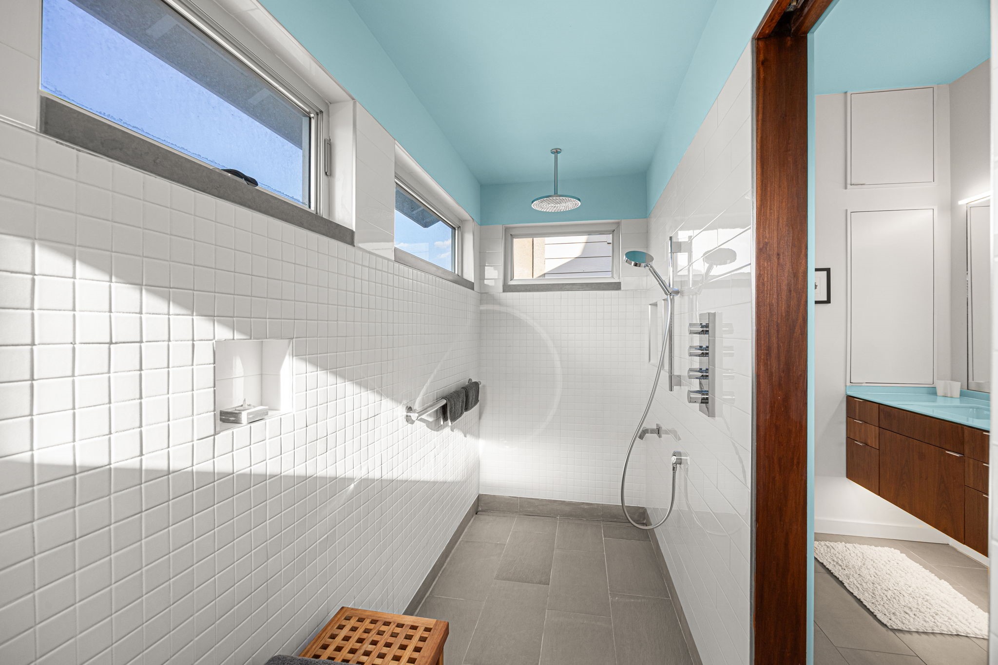 5811 Rose Street Houston, TX 77007 - Photo 21 of 38 The oversized shower with strategically placed windows on three sides captures both morning and evening sun, while still creating a private space to wake-up or wind down. The Walnut cabinetry brings in the natural wood element, complimenting the relaxing color palette of this space. Welcome to your personal home spa!