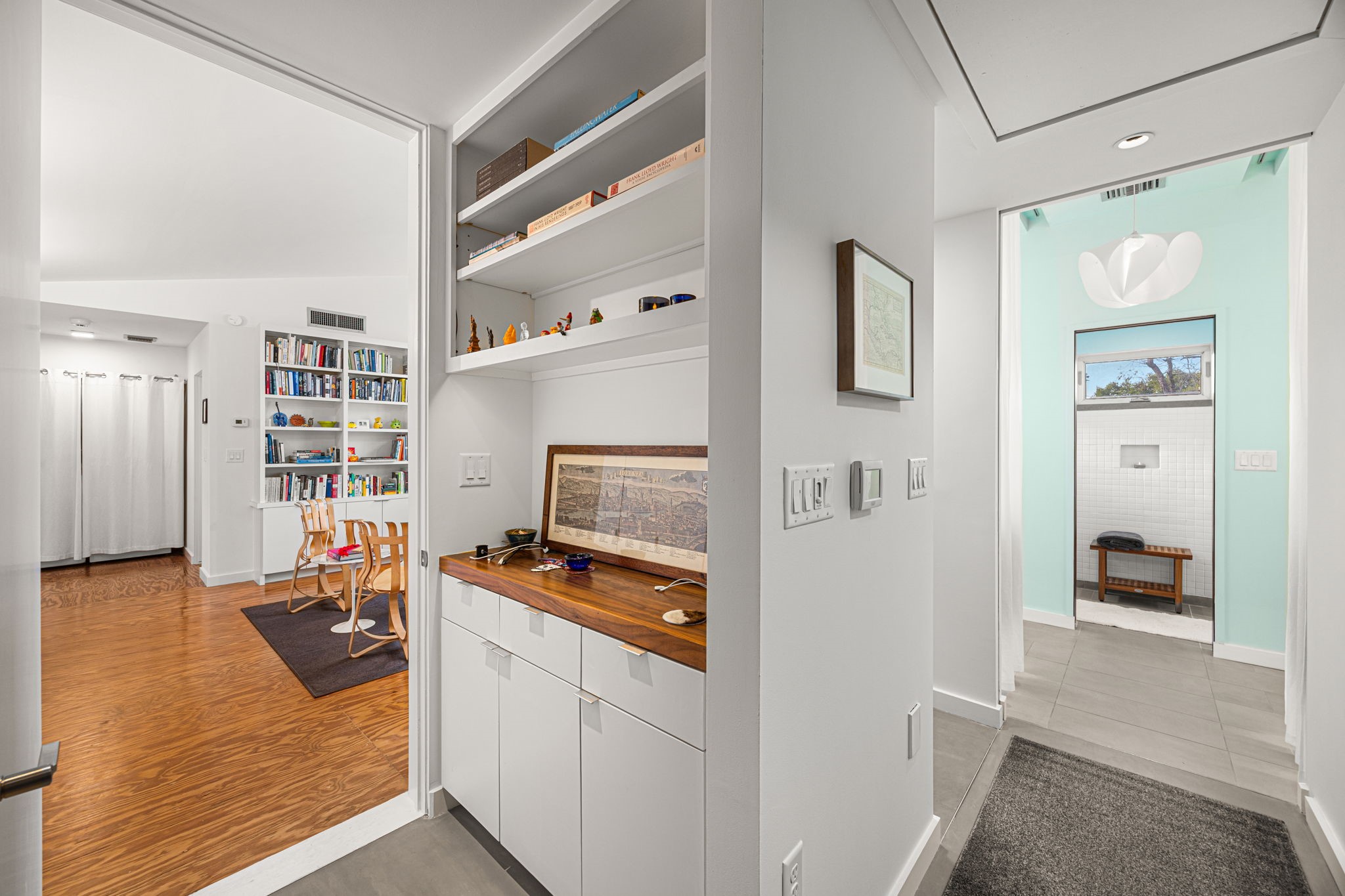 5811 Rose Street Houston, TX 77007 - Photo 24 of 38 View from the primary suite entry, looking towards the library/secondary bedroom (left) and primary bathroom (right). This area features the "drop station" built for cell phone and watch charging, wallets and jewelry to be dropped off BEFORE entering the peaceful primary retreat.