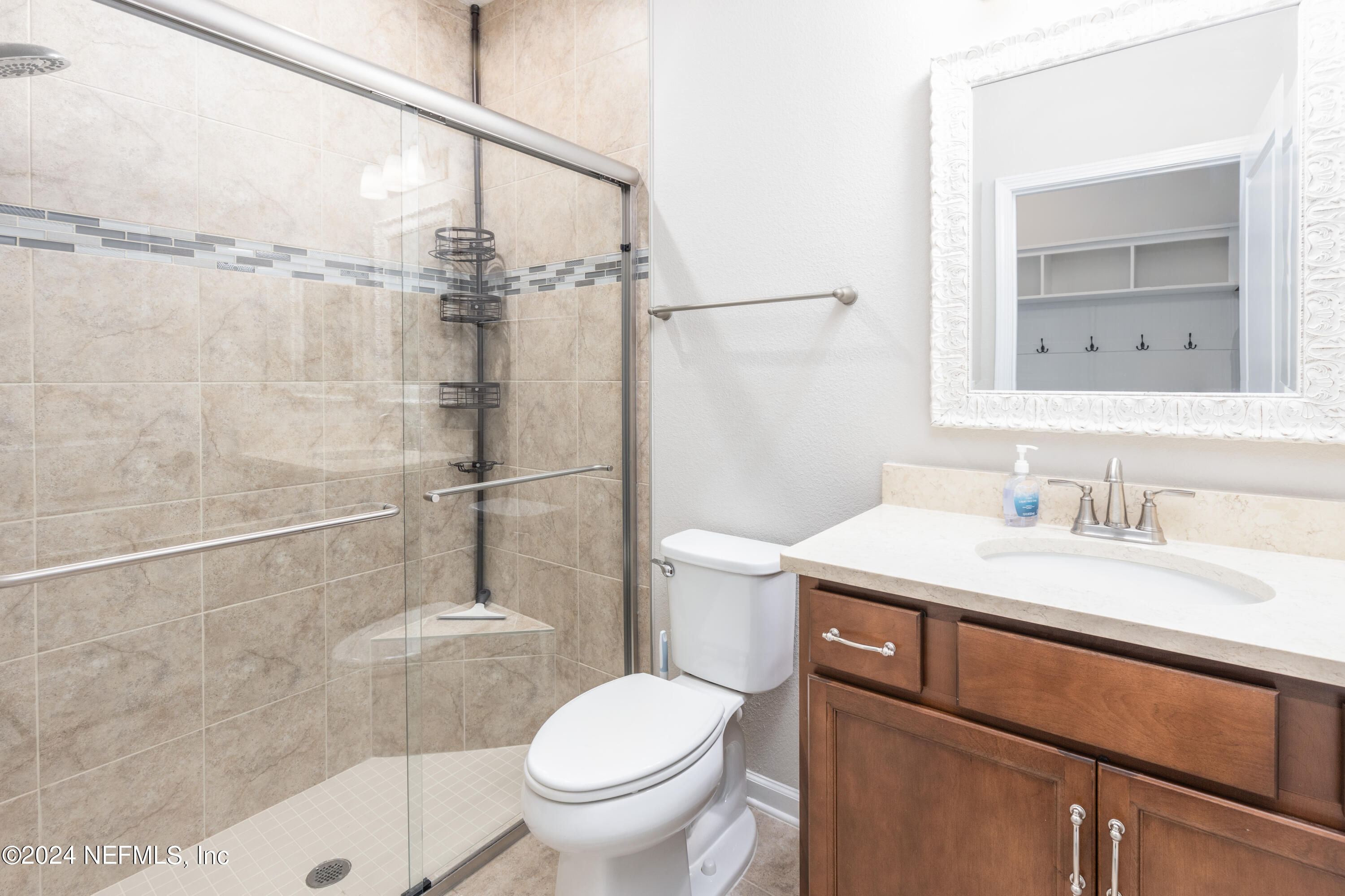 400 Weathered Edge Drive St. Augustine, FL 32092 - Photo 11 of 35 a bathroom with a sink toilet vanity and shower