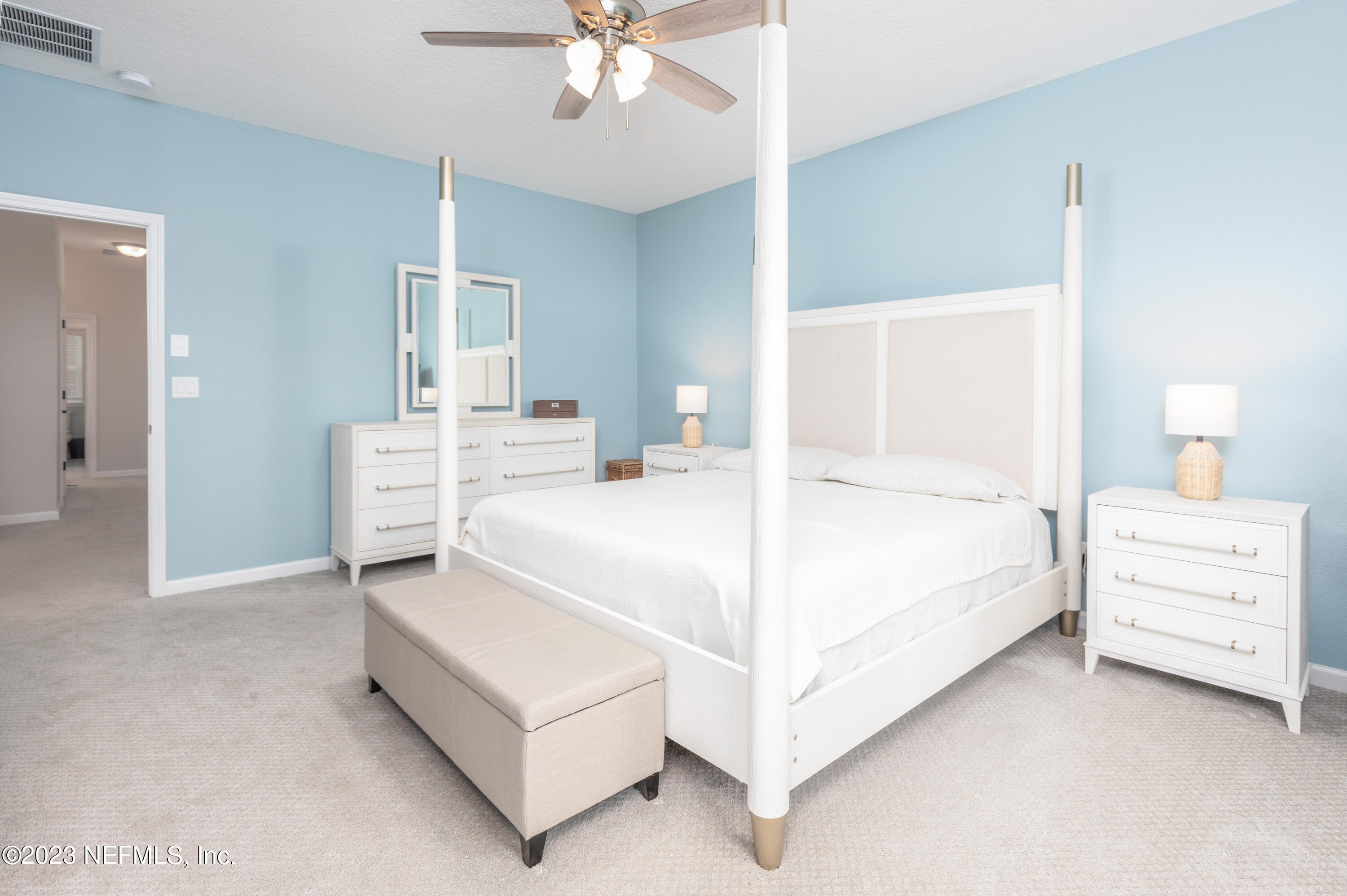 400 Weathered Edge Drive St. Augustine, FL 32092 - Photo 12 of 35 a room with a bed and a chandelier